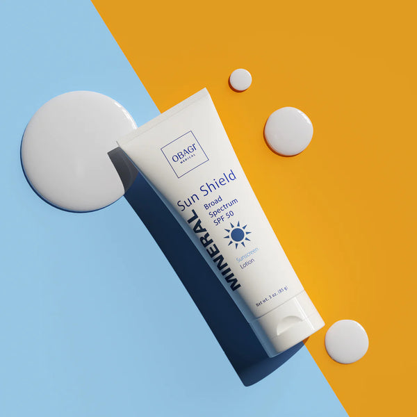 An image of Obagi Mineral Broad Spectrum SPF 50 with a light blue and yellow background.