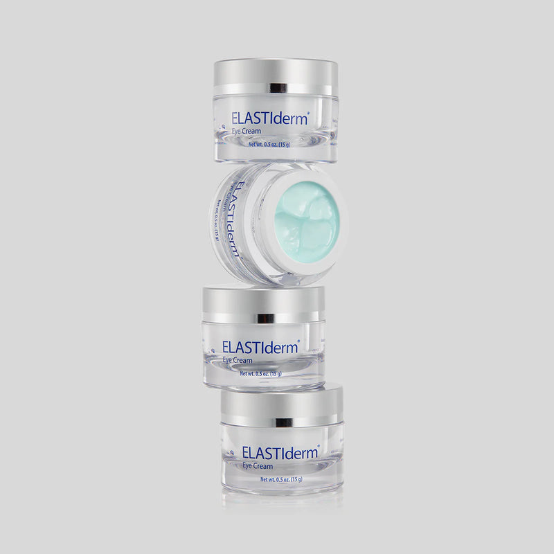 An image of a stack of four containers of Obagi ELASTIderm Eye Cream with one has an open cap and its content showing.