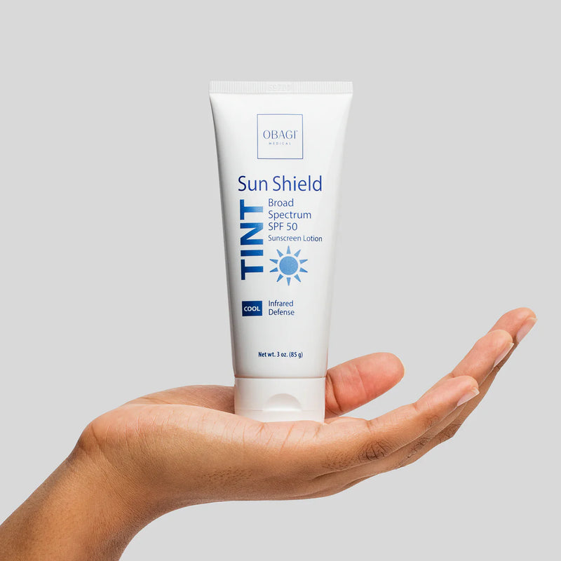 An image of Obagi Sun Shield Tint Cool SPF50 standing in a palm of a hand.