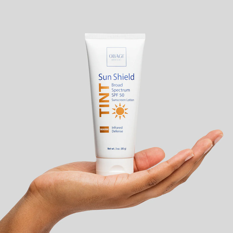 An image of Obagi Sun Shield Tint Warm SPF50 standing in a palm of a hand.