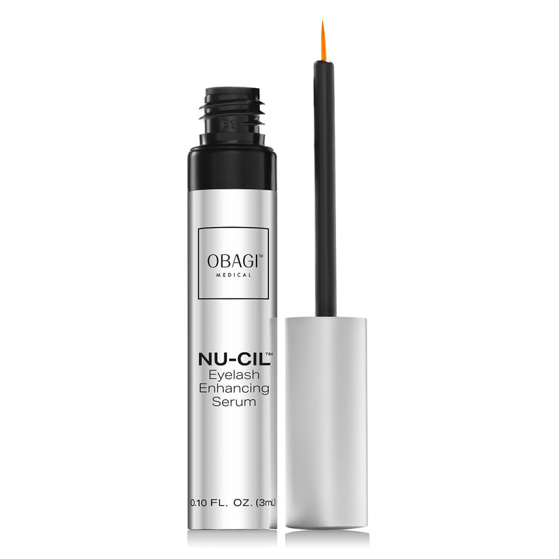 An image of an open bottle of Nu-Cil™ Eyelash Enhancing Serum with it's applicator standing beside it.